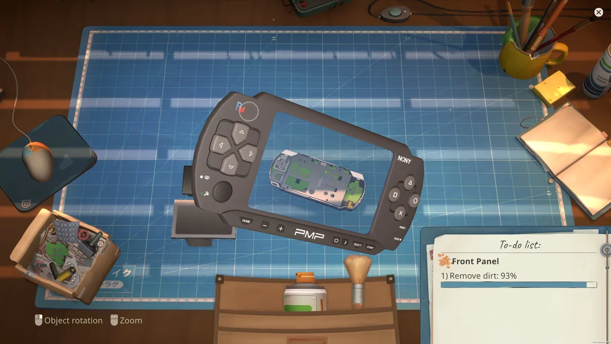 ReStory repair bench with a handheld console opened for inspection